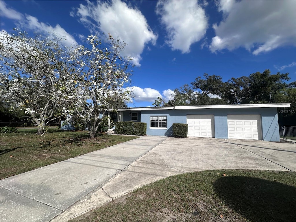 1951 S Crystal Lake Dr, Orlando, FL 32806 - ranch-style house featuring a garage and a front yard