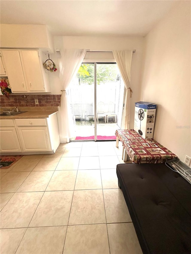 interior space featuring light tile patterned floors and sink