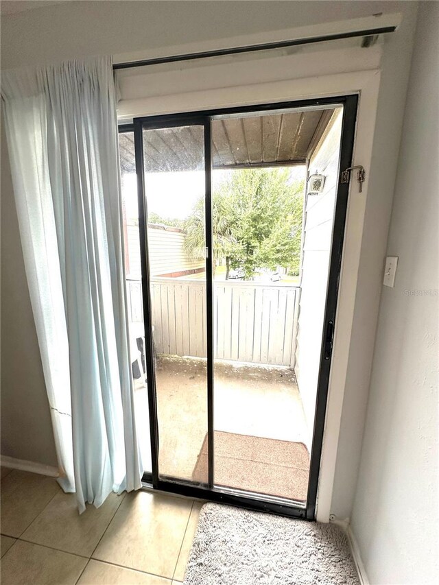 doorway to outside featuring light tile patterned flooring