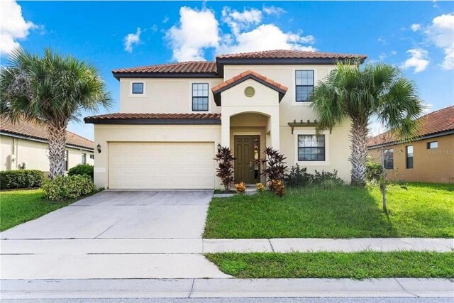 mediterranean / spanish-style home with a front lawn and a garage