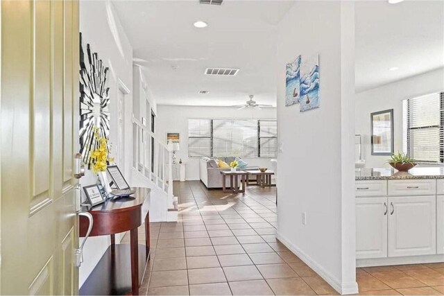 tiled foyer with ceiling fan