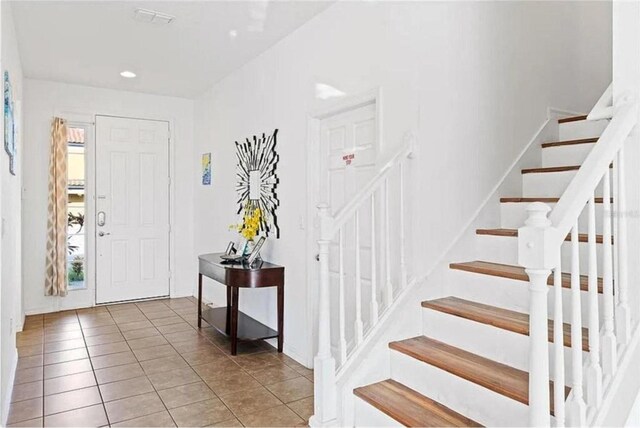 entryway with plenty of natural light and tile patterned floors