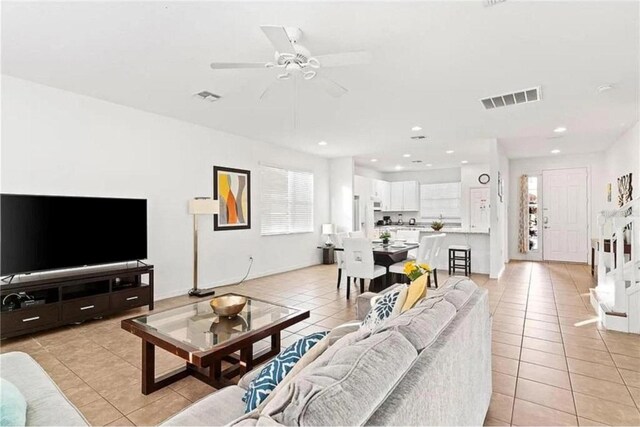 living area with light tile patterned flooring, visible vents, recessed lighting, and a ceiling fan