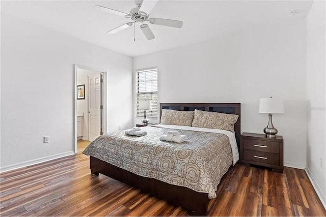 bedroom with connected bathroom, wood finished floors, baseboards, and ceiling fan