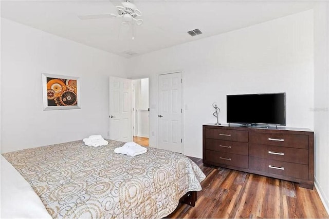 bedroom with visible vents, a ceiling fan, and dark wood-style flooring