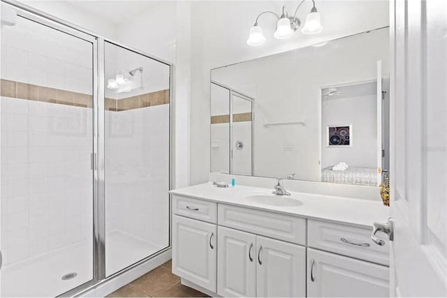 bathroom featuring vanity, a shower stall, and tile patterned floors