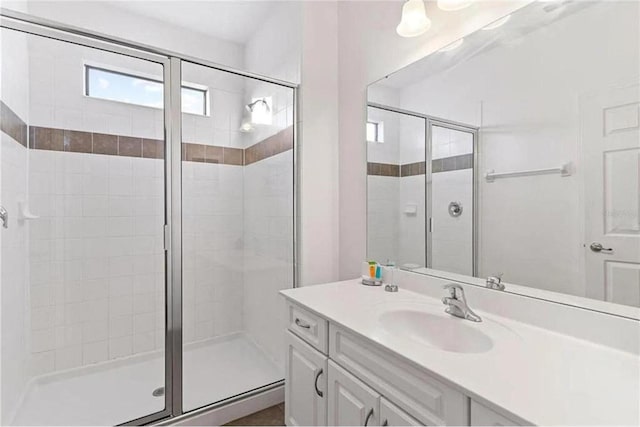 bathroom with vanity and a shower stall