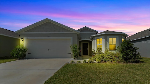 view of front facade featuring a lawn and a garage