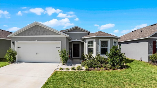 view of front of home featuring a front yard and a garage