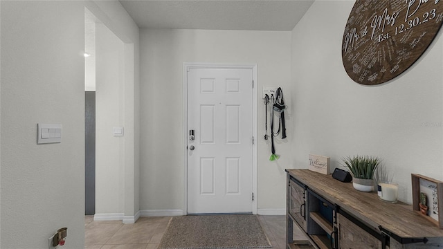 foyer entrance featuring light tile patterned flooring