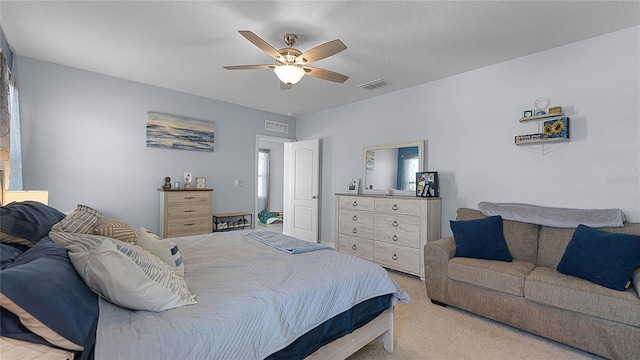 bedroom with ceiling fan and light colored carpet