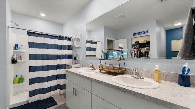 bathroom featuring a shower with curtain and vanity