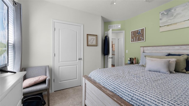 bedroom with light colored carpet