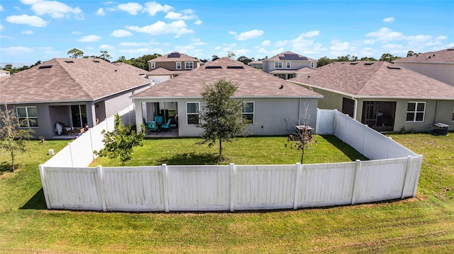 back of property with a patio area and a yard