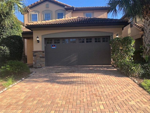 mediterranean / spanish-style house with a garage