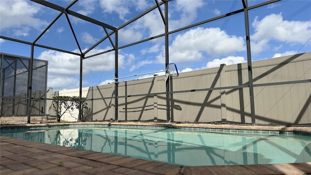 view of swimming pool with a lanai