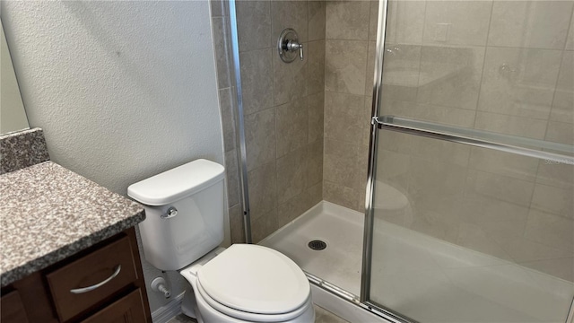 bathroom with walk in shower, vanity, and toilet