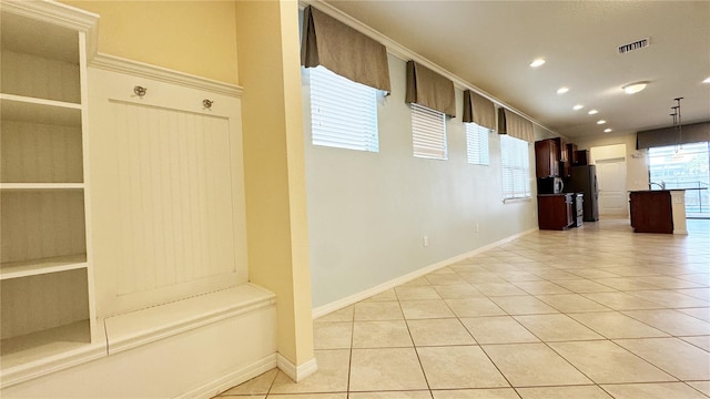 mudroom with light tile patterned floors