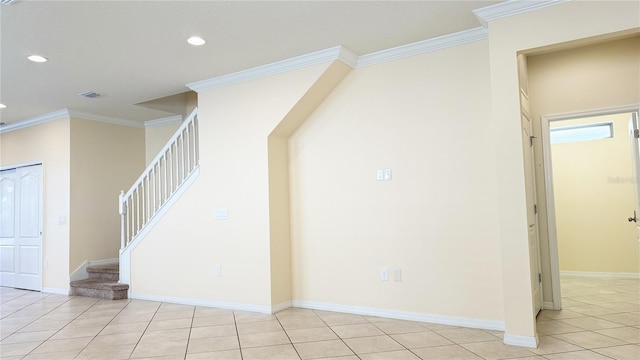 staircase with tile patterned floors and crown molding