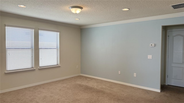 carpeted empty room with ornamental molding and a textured ceiling