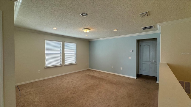 carpeted empty room with a textured ceiling and crown molding