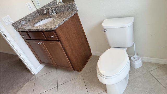 bathroom with vanity, tile patterned floors, and toilet