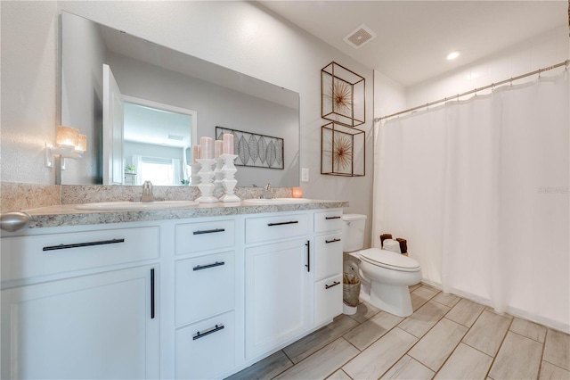 bathroom with vanity, toilet, and a shower with curtain