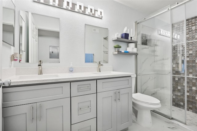 bathroom with vanity, toilet, and a shower with shower door