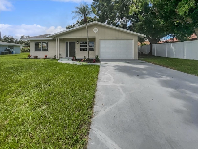 single story home featuring a garage and a front yard