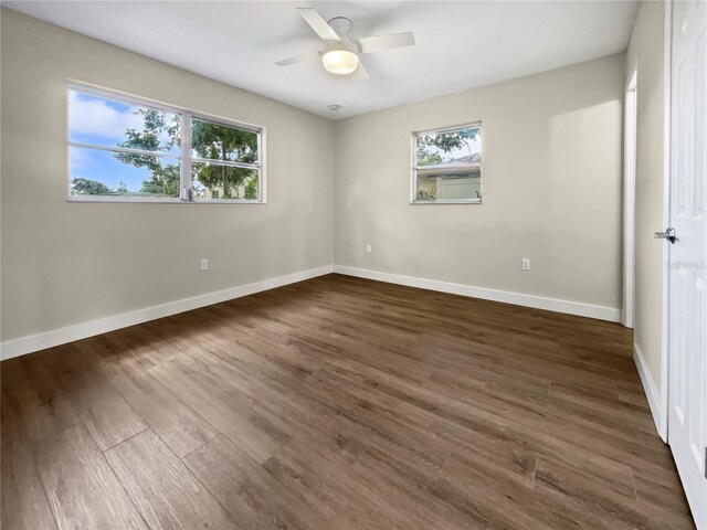 spare room featuring dark hardwood / wood-style flooring and ceiling fan