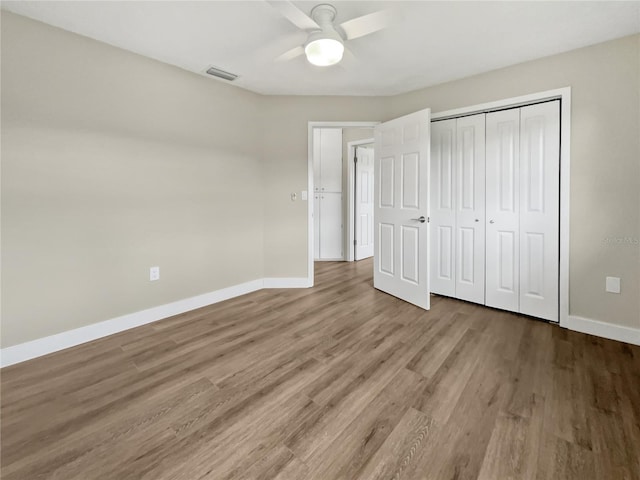 unfurnished bedroom with a closet, ceiling fan, and hardwood / wood-style flooring