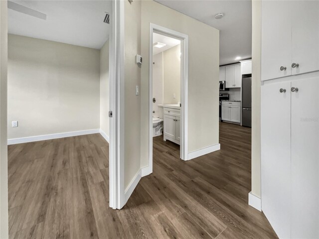 corridor featuring wood-type flooring