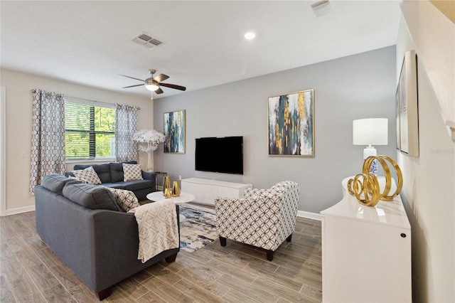 living room with ceiling fan and hardwood / wood-style floors