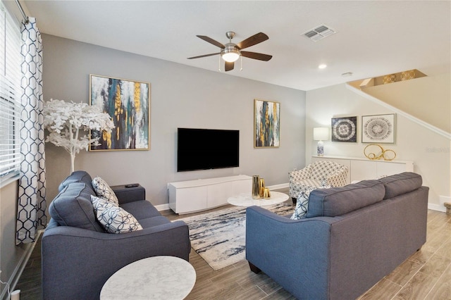 living room with hardwood / wood-style floors and ceiling fan