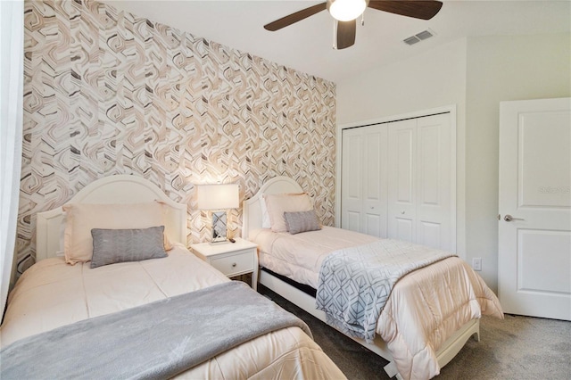 carpeted bedroom featuring a closet and ceiling fan