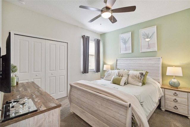 bedroom featuring dark carpet, a closet, and ceiling fan