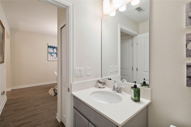 bathroom featuring hardwood / wood-style flooring and vanity