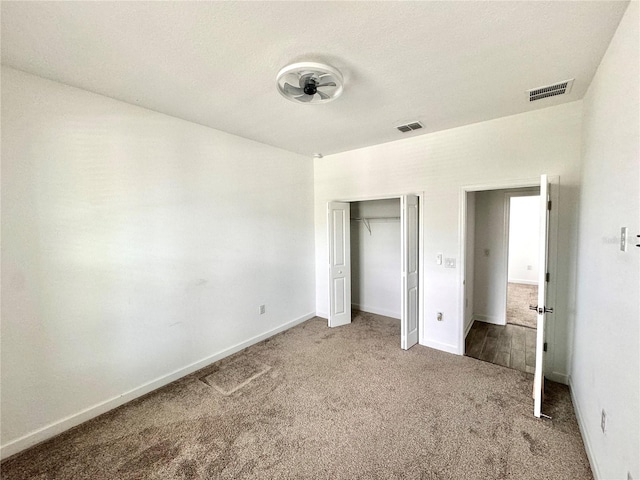 unfurnished bedroom featuring a closet and carpet