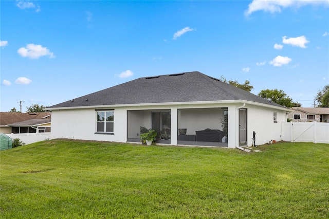 rear view of property with a yard