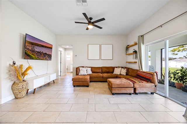 living room featuring ceiling fan and light tile patterned floors