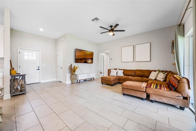 living room featuring light tile patterned floors and ceiling fan