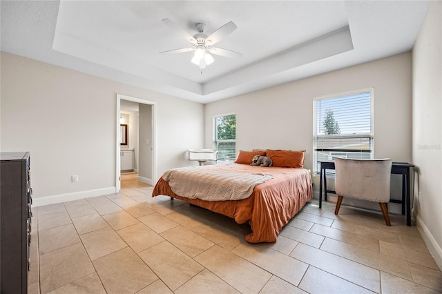 bedroom with a raised ceiling and ceiling fan