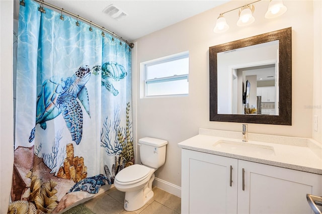 bathroom with tile patterned flooring, vanity, and toilet