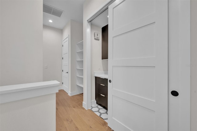 hall with light hardwood / wood-style floors