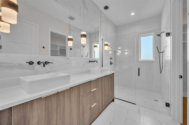 bathroom featuring tile walls, an enclosed shower, vanity, and tasteful backsplash