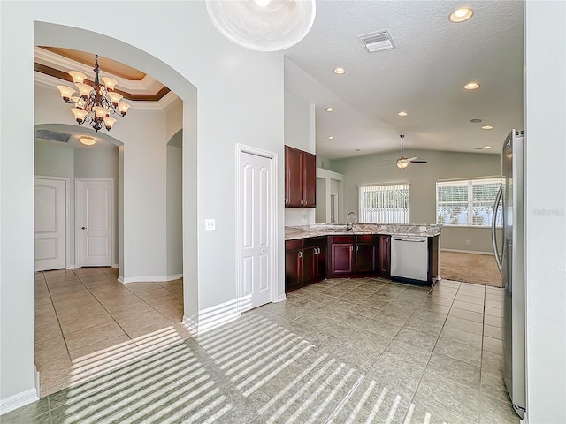 kitchen with ceiling fan with notable chandelier, light stone counters, sink, appliances with stainless steel finishes, and light tile patterned flooring