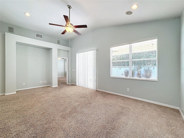 unfurnished bedroom featuring vaulted ceiling, light carpet, and ceiling fan