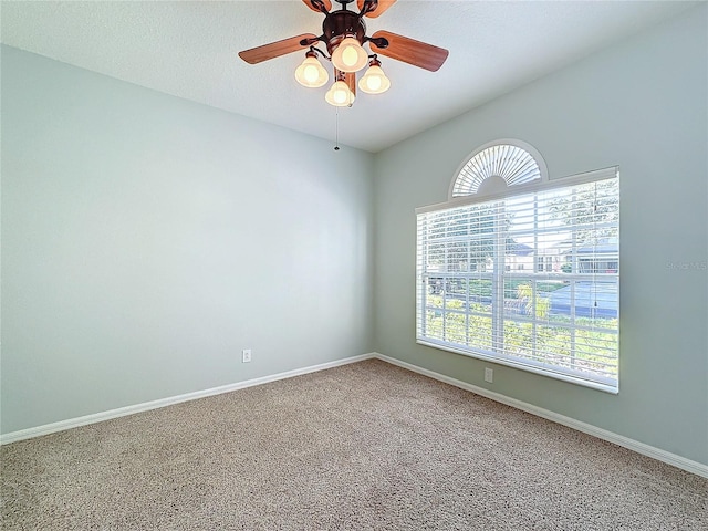 unfurnished room featuring a healthy amount of sunlight, ceiling fan, and carpet floors