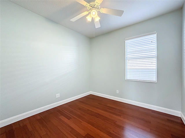 empty room featuring ceiling fan, dark hardwood / wood-style flooring, and a textured ceiling