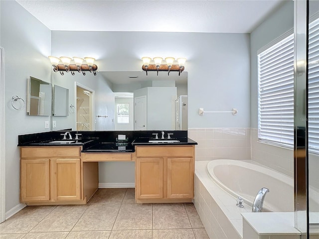 bathroom featuring tile patterned flooring, vanity, and a healthy amount of sunlight